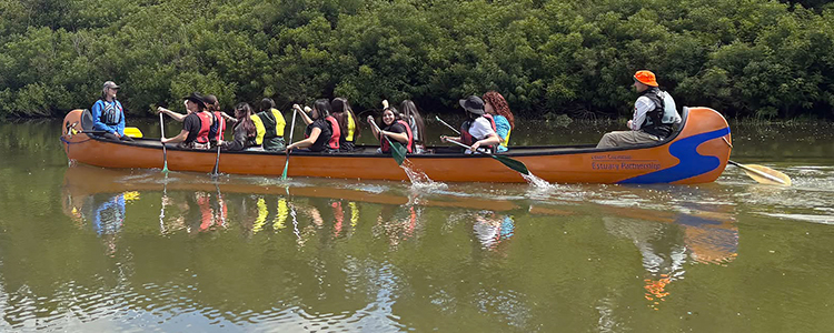 Big orange canoe on the water